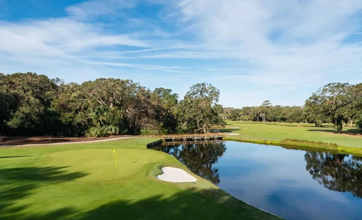 A wood bridge to navigate the water hazard placed next to a green on the Turtle Point course
