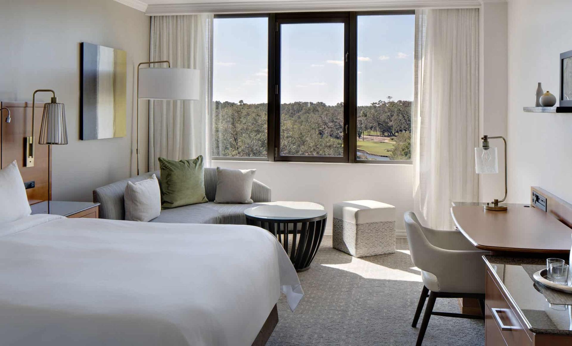 Modern double bed room at the Sawgrass Marriott Golf Resort & Spa with window views of the course
