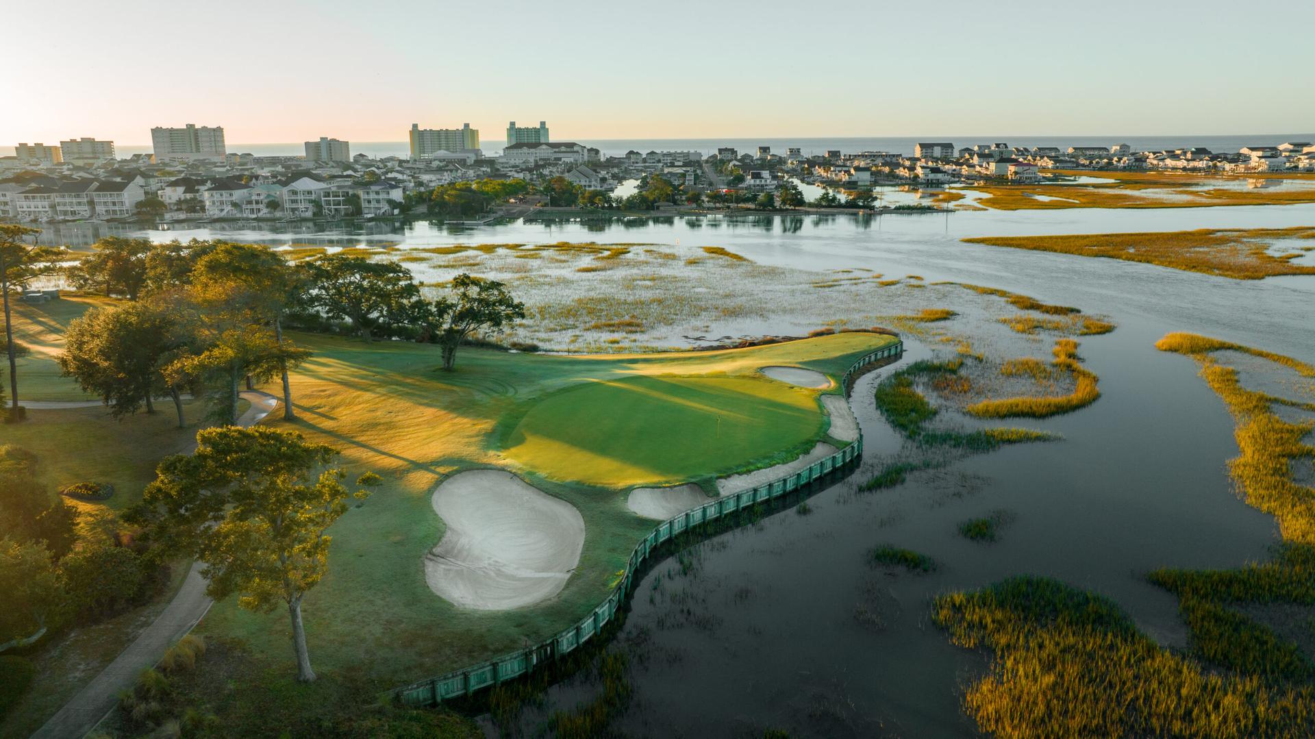A smooth green elevated from the water hazard