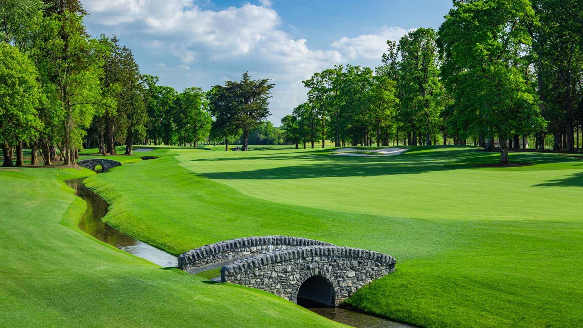 Stone bridge crossing a creek on a pristine fairway.