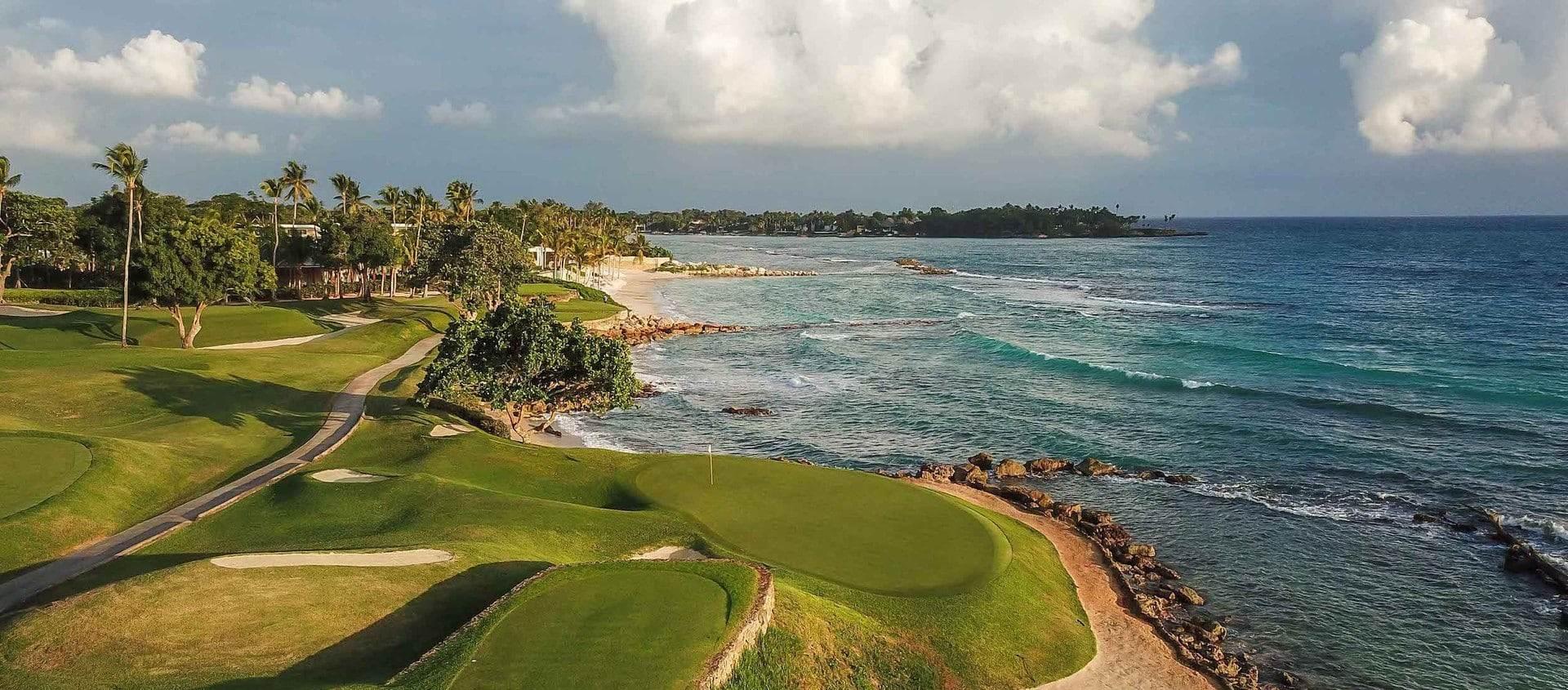 Panoramic view of the course with coastal views and a well-maintained green
