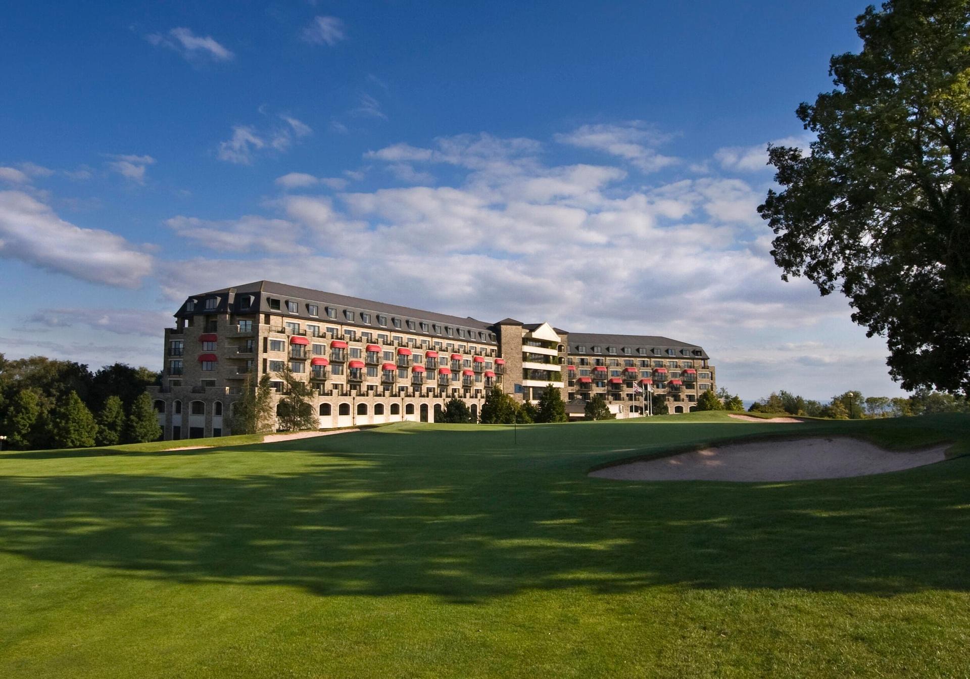 Modern resort building overlooking golf course greens.