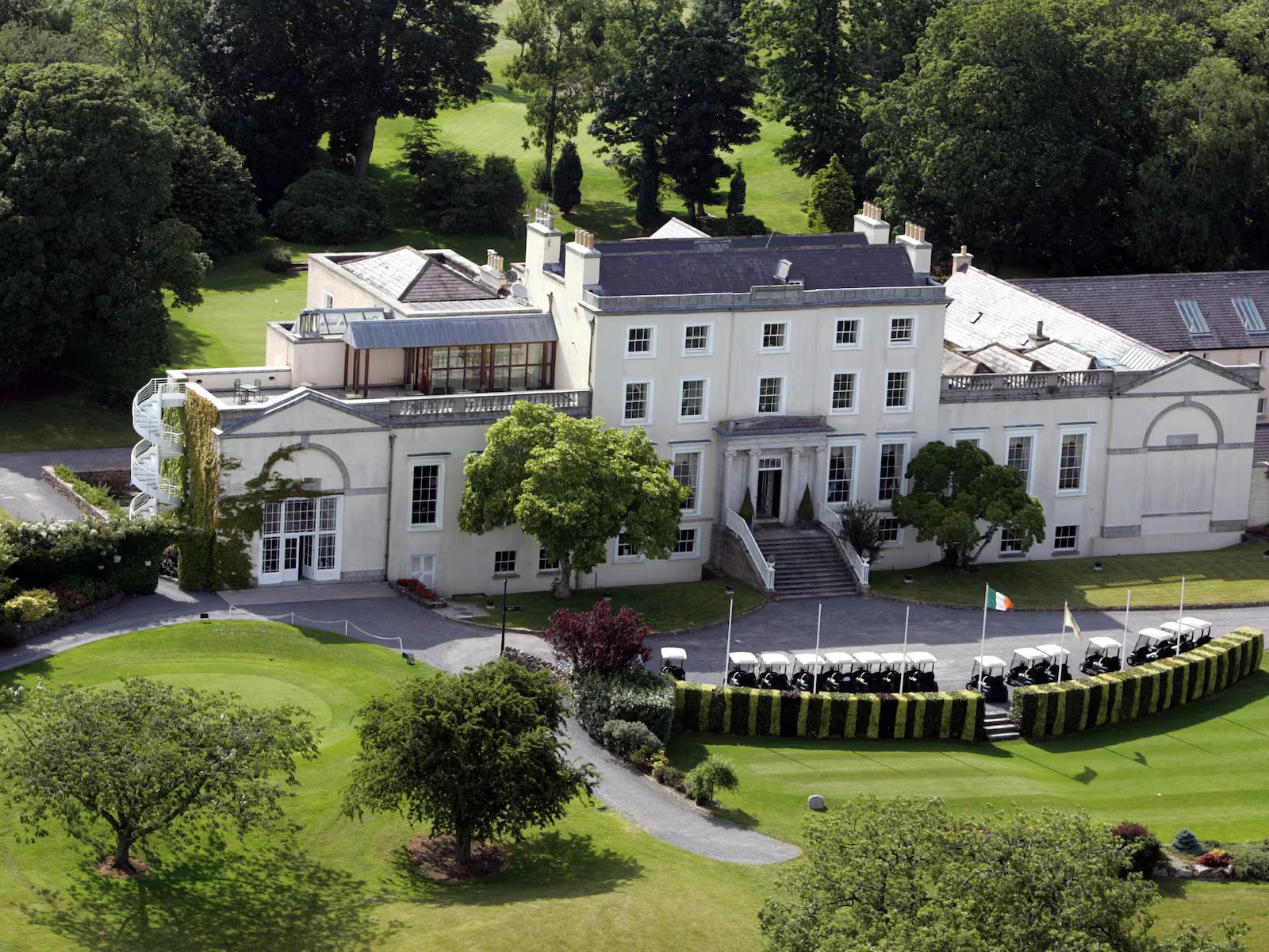Classic resort building surrounded by lush gardens.