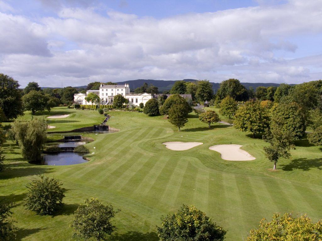 Stunning aerial view of a golf course with sand bunkers and ponds.