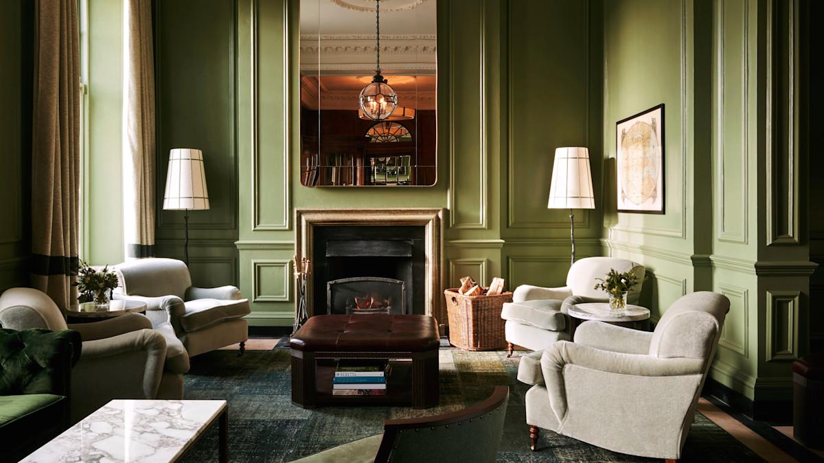 Seating area in reception of the Glensaegles resort with a firepit and modern yet mature design