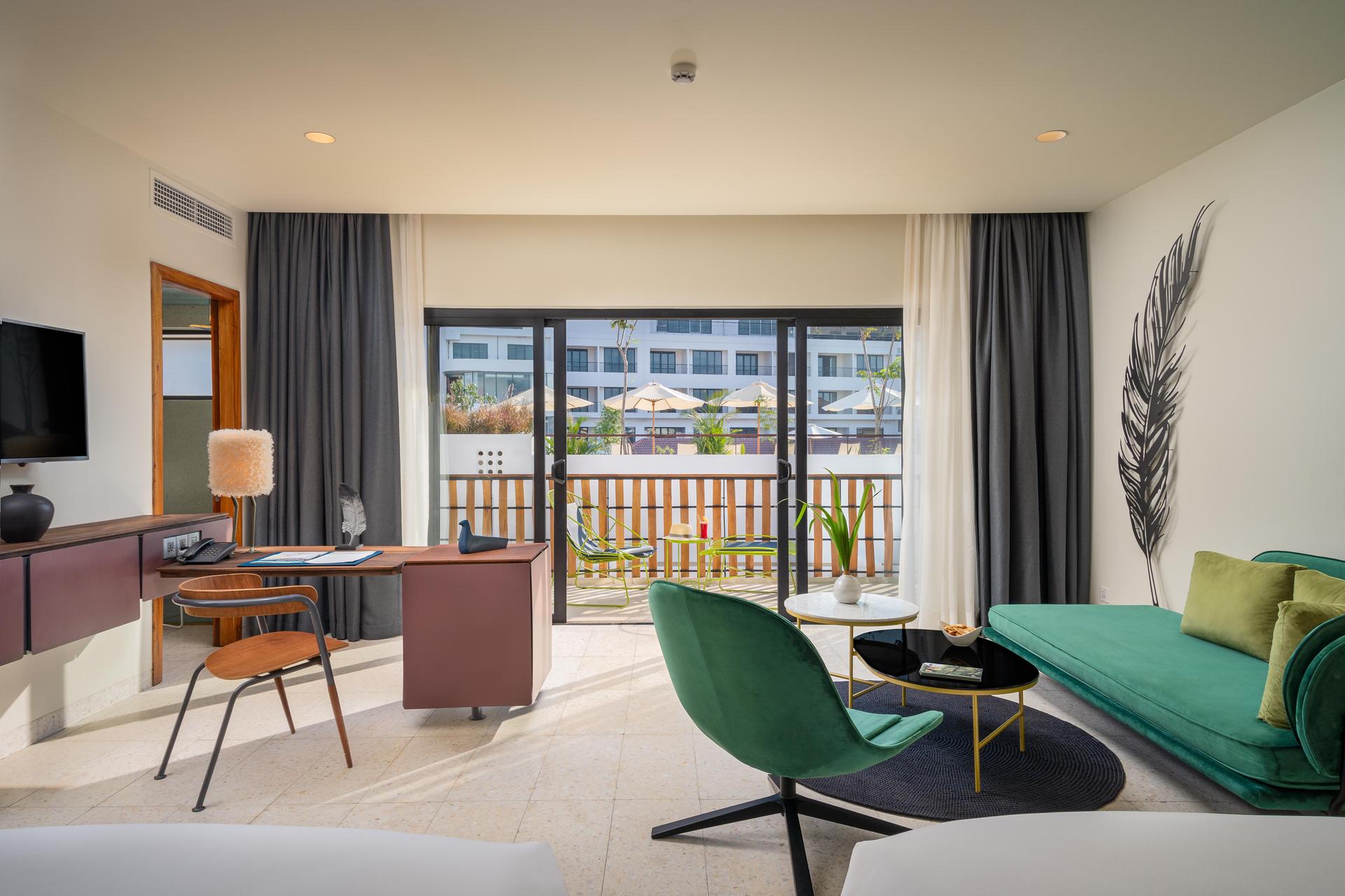 Lounge area in a hotel room with a balcony at The Aviary Hotel