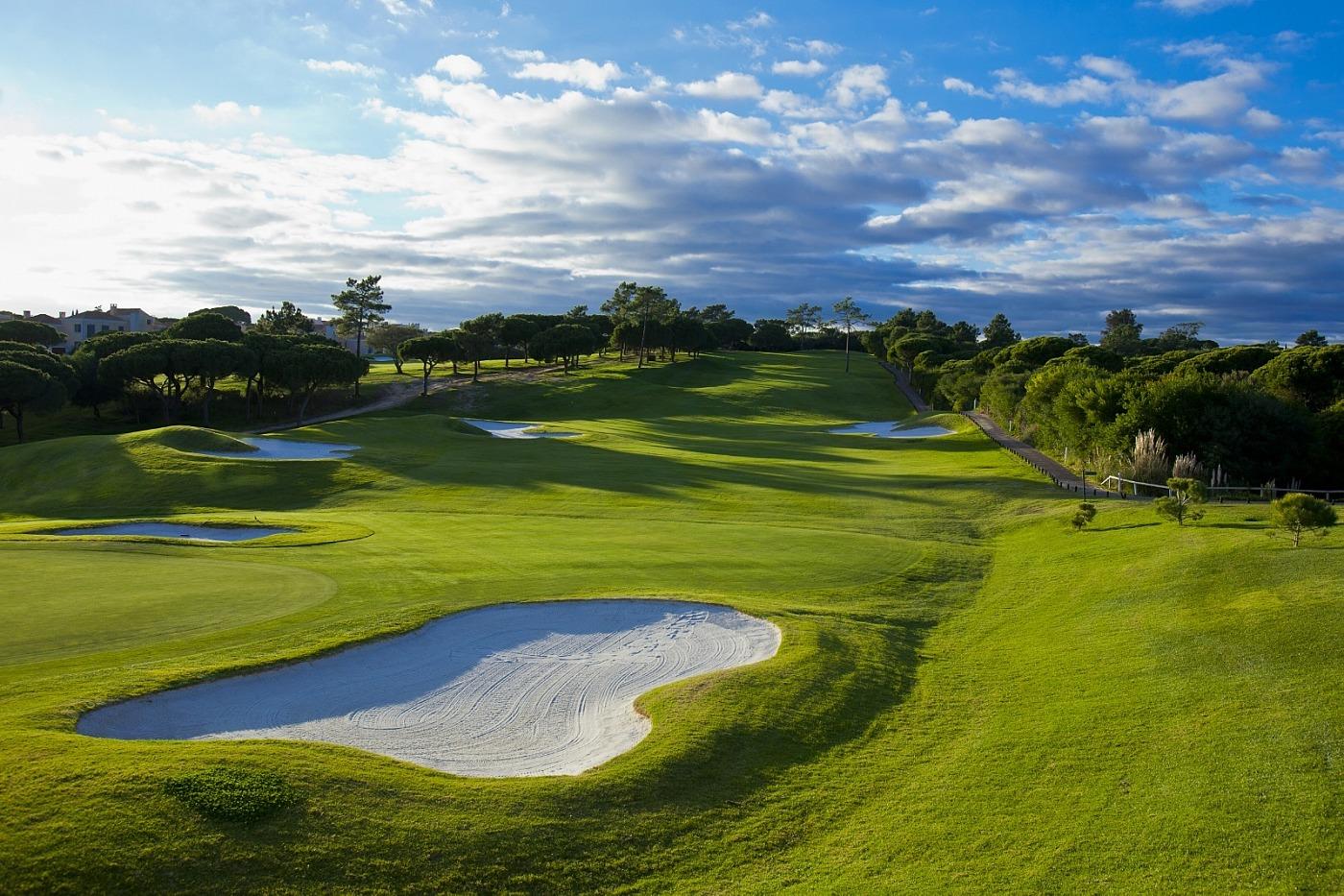 A wide fairway leading to a smooth green surrounded by sand bunkers