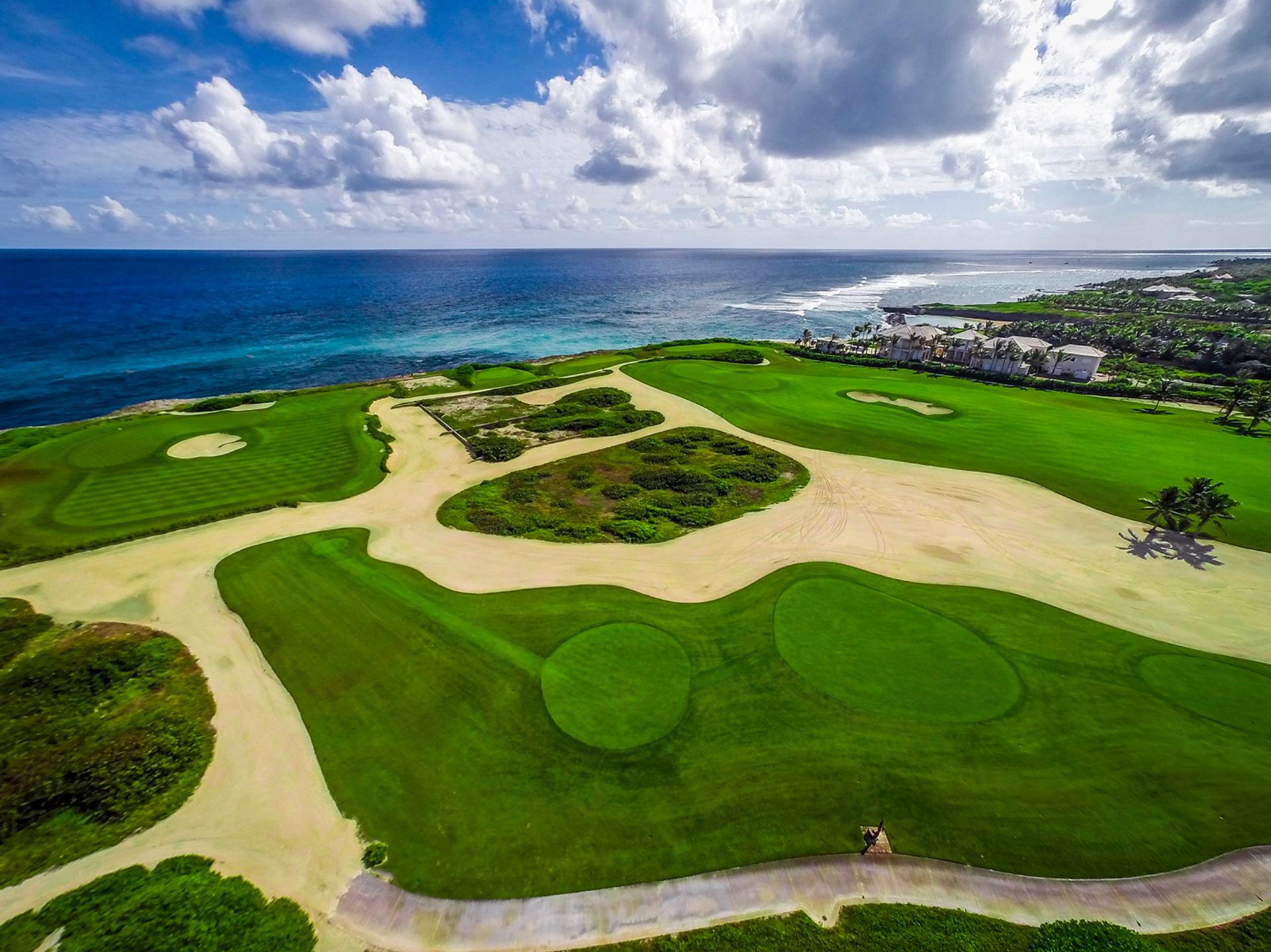 Birdseye view of a sandy rough surrounding wide fairways and smooth greens