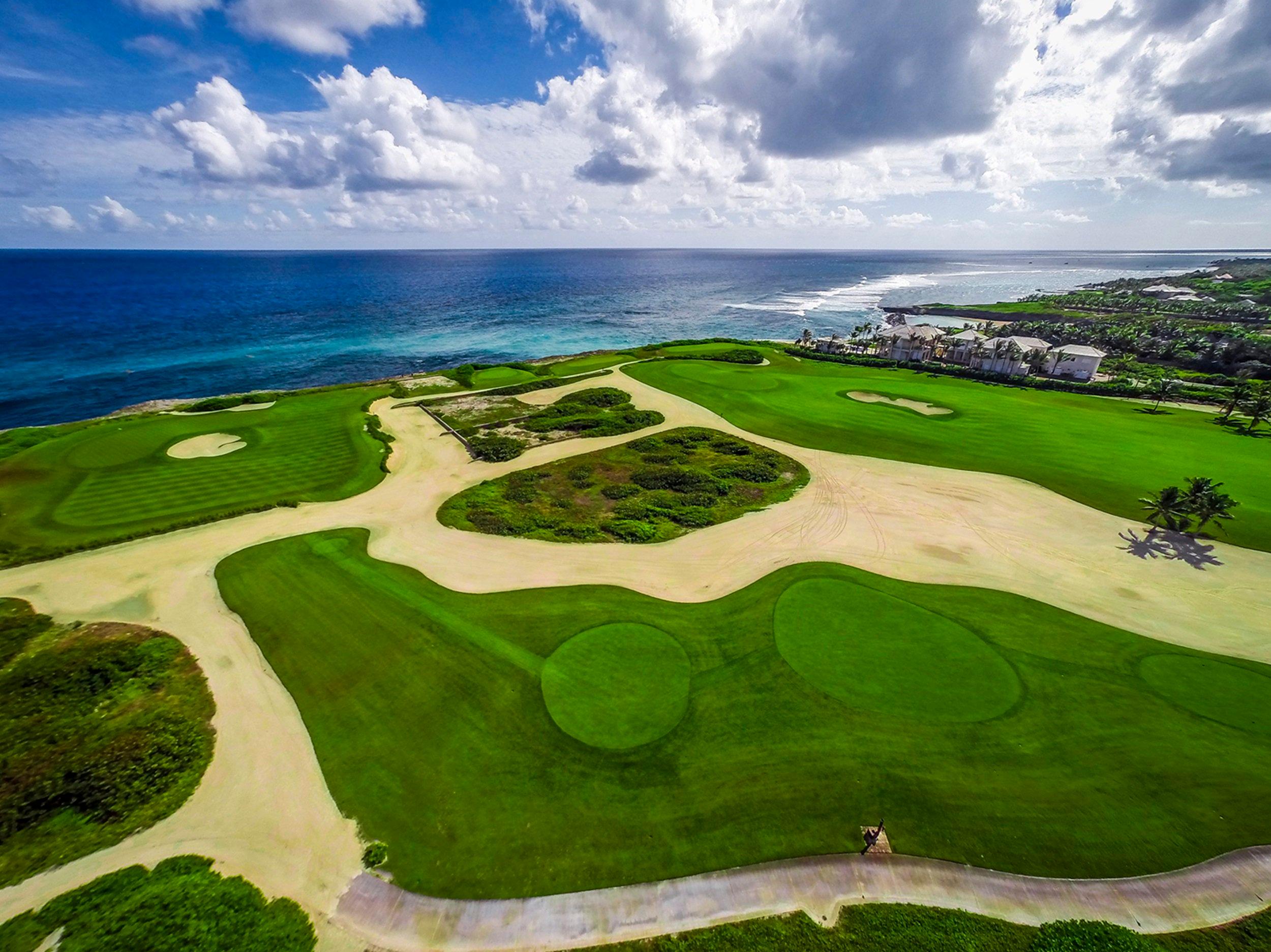 Birdseye view of a sandy rough surrounding wide fairways and smooth greens