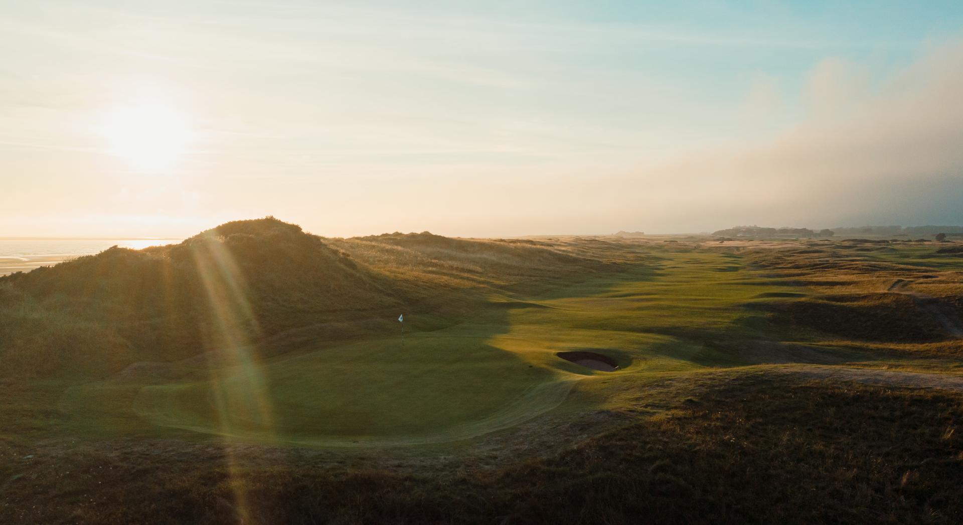 Narrow fairway surrounded by thick rough at Royal Troon at sunset