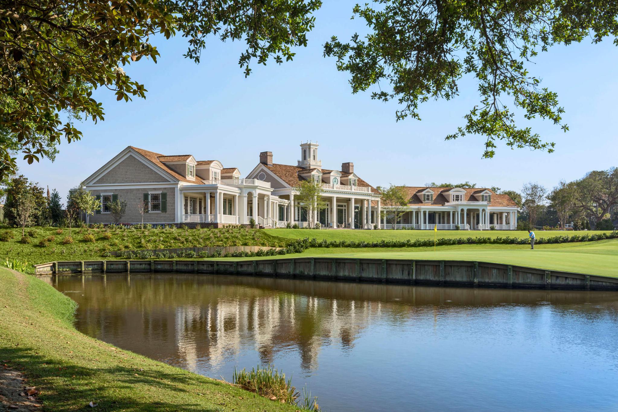 The Kiawah Island clubhouse looking over a golfer putting on the green