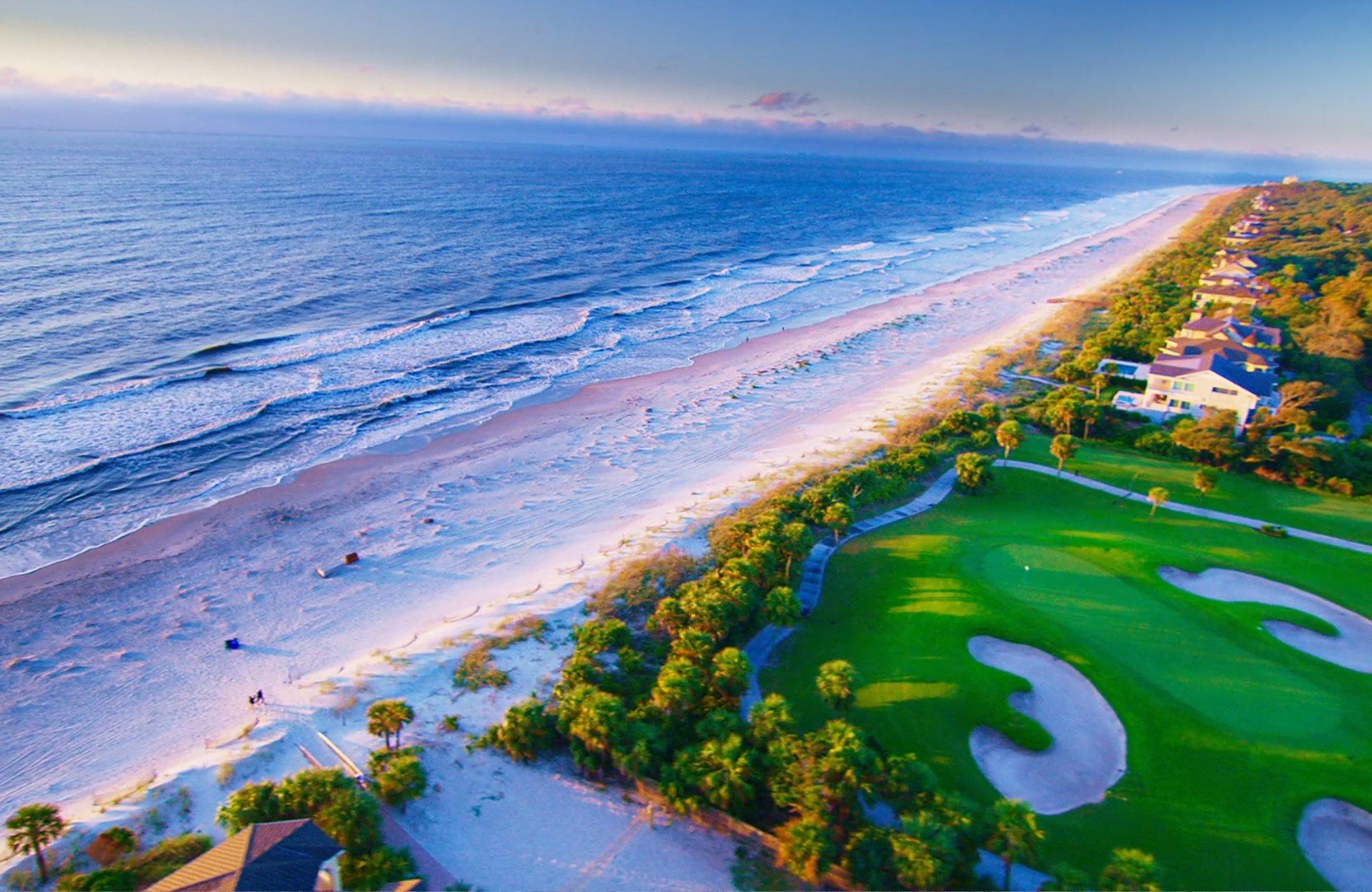 Aerial view of the golf course leading to the beach with sea views