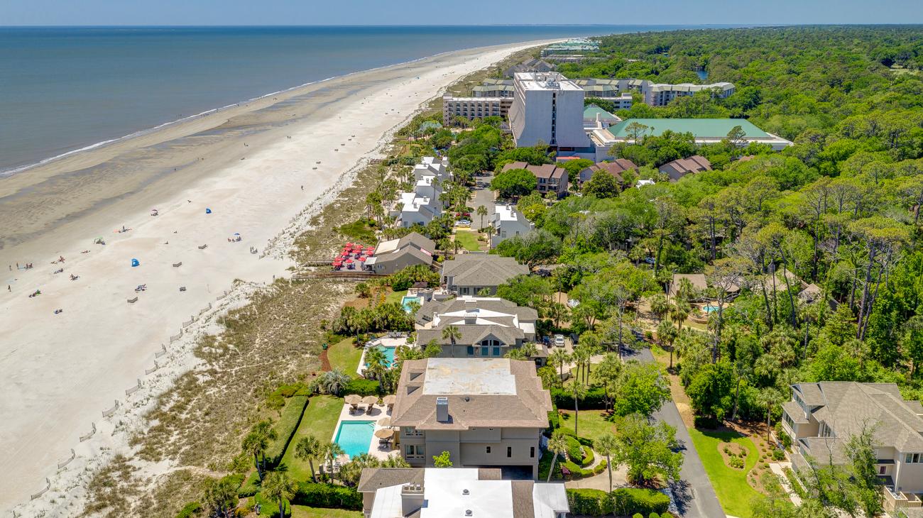 Overview of the beach side resort with sea views surrounded by trees