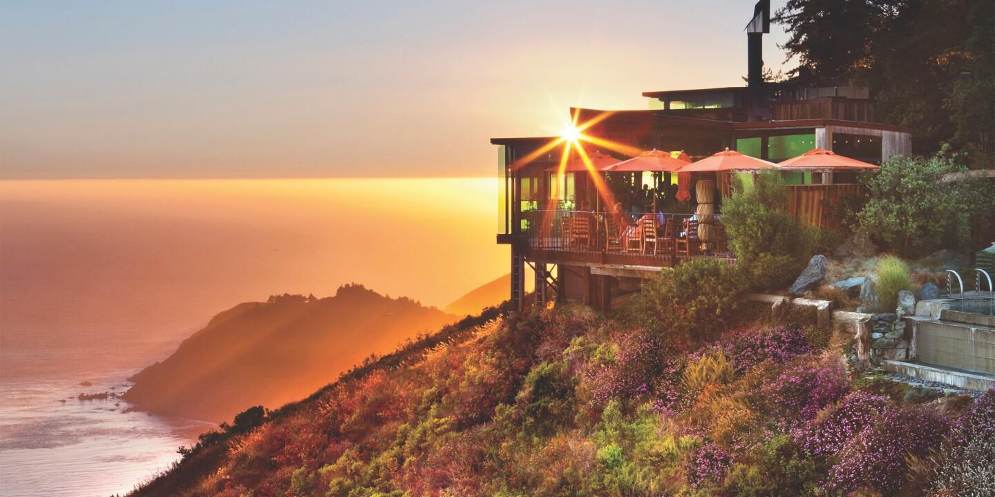 Sun setting over the cliffside hotel with coastal views