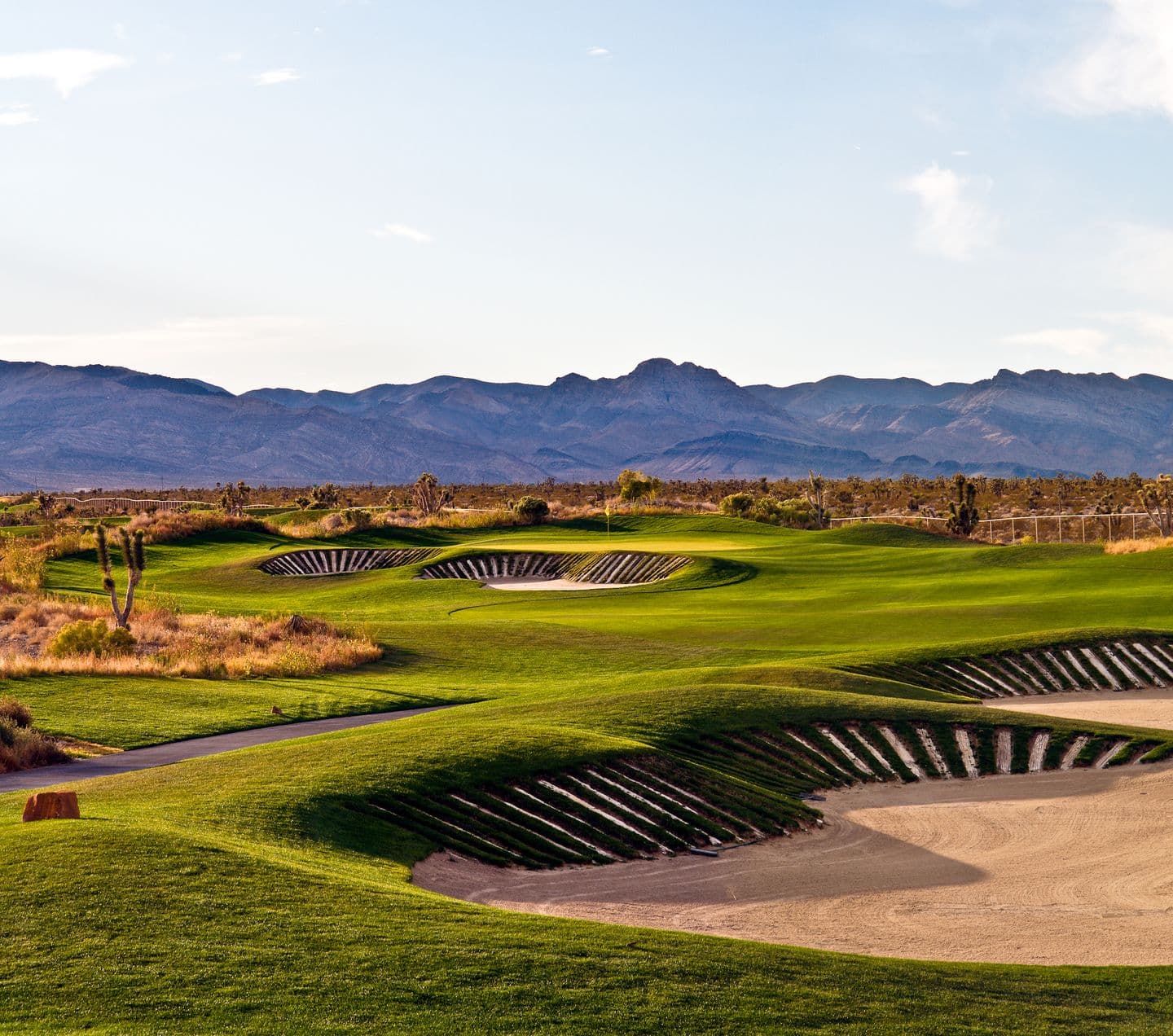 Deep sand bunkers surrounding a smooth green on the Sun Mountain Course