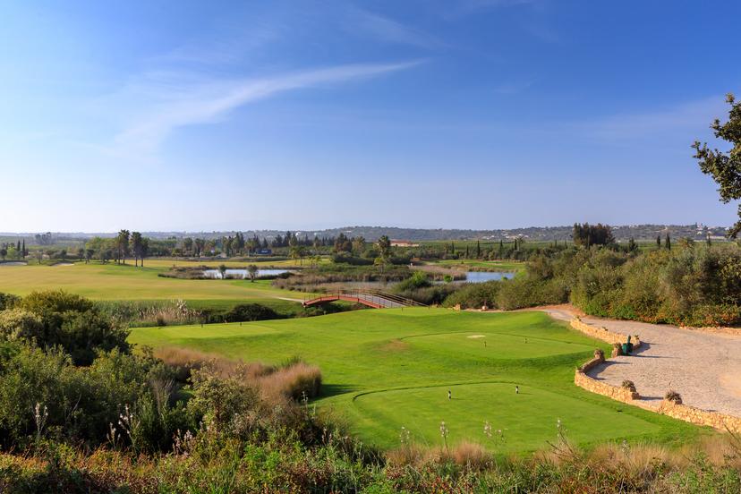 Tee shot over water to a wide fairway with water on the right
