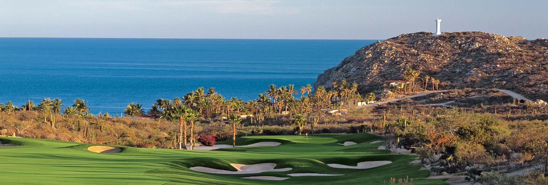 Panoramic view of a green littered with sand bunkers and lovely sea views