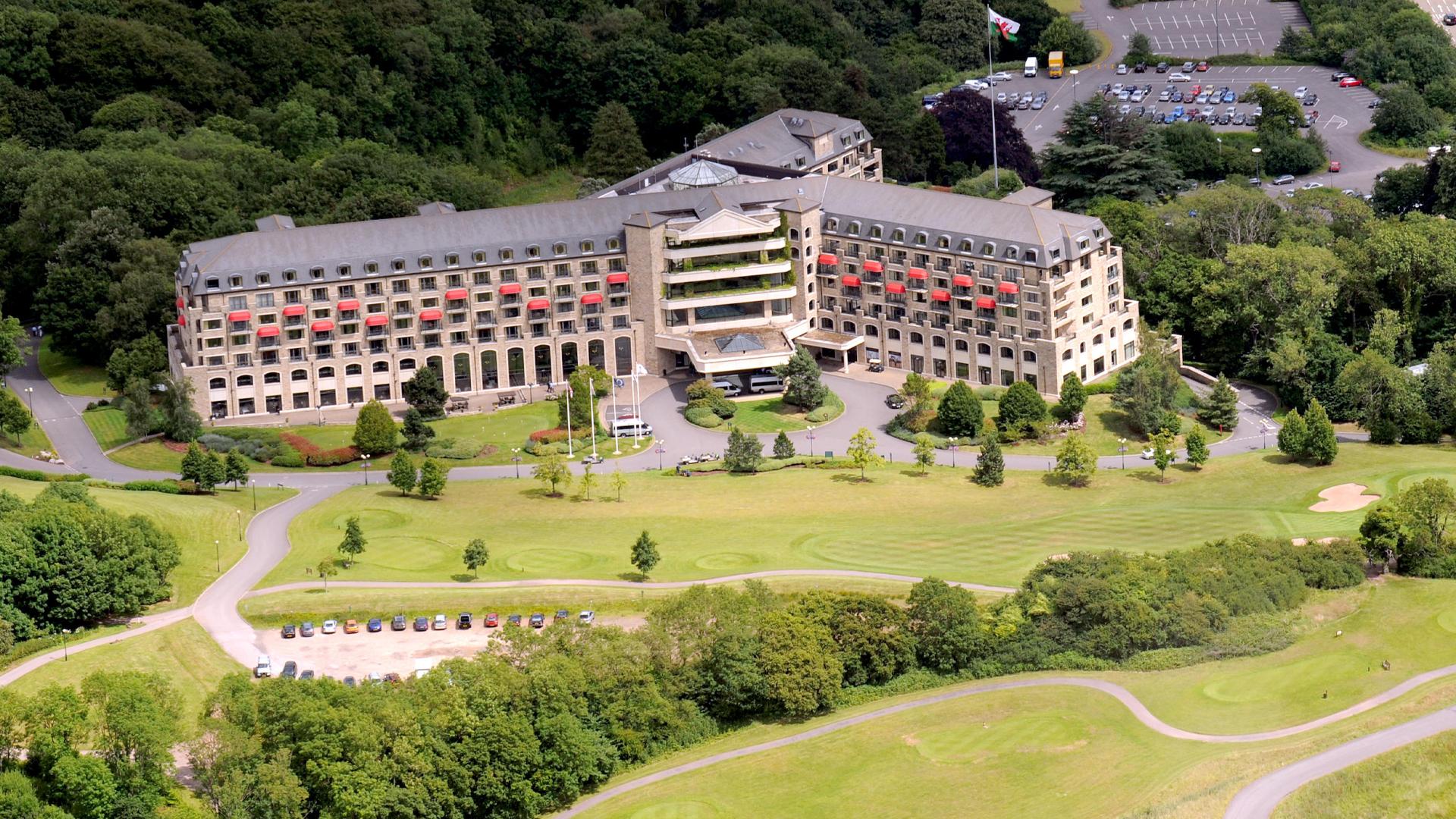 Large resort hotel with stone exterior and arched windows.