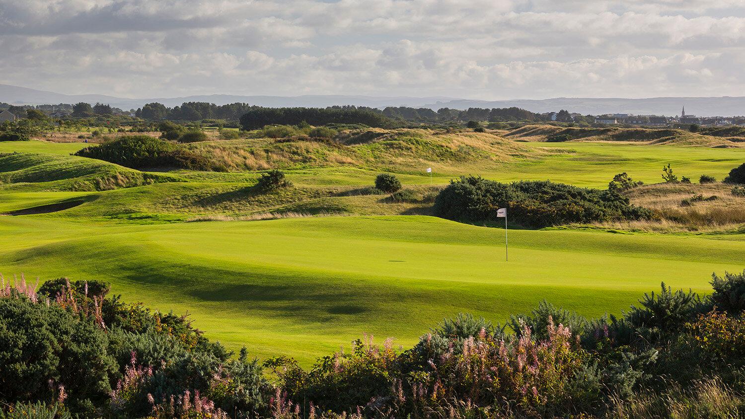 Panoramic view if the well-maintained green and rolling dunes at the Dundonald links course