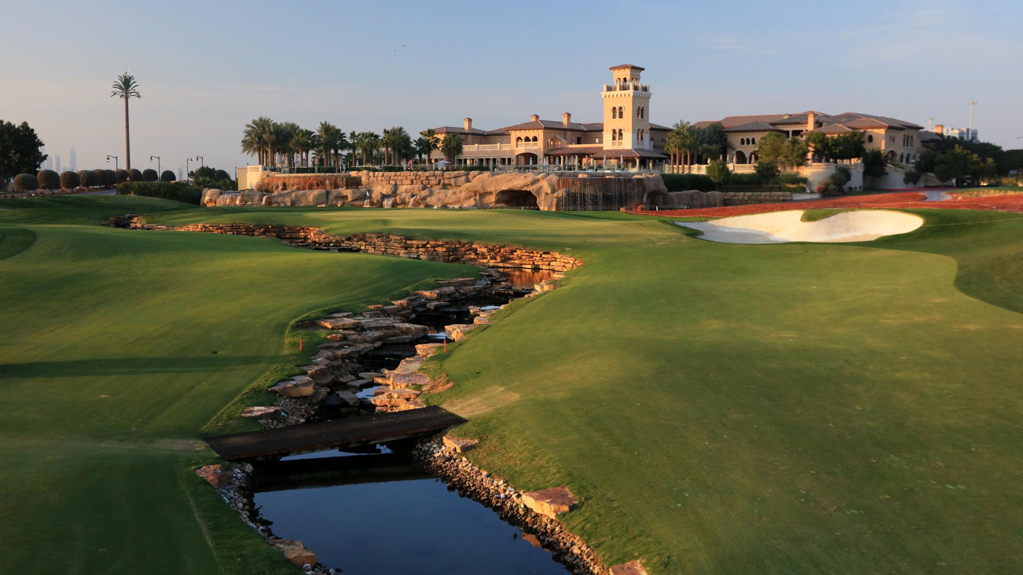 The Earth Course Clubhouse at Jumeirah Golf Estates overlooking winding fairways separated a river