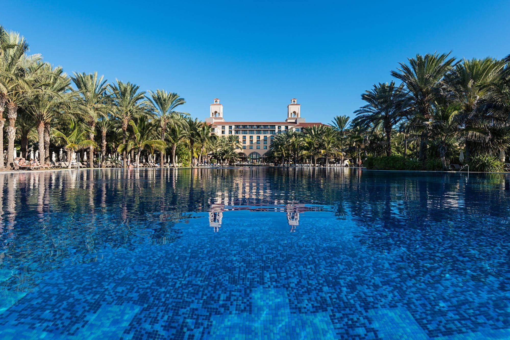 Outdor swimming pool with the Gran Hotel Lopesan Meloneras in the background