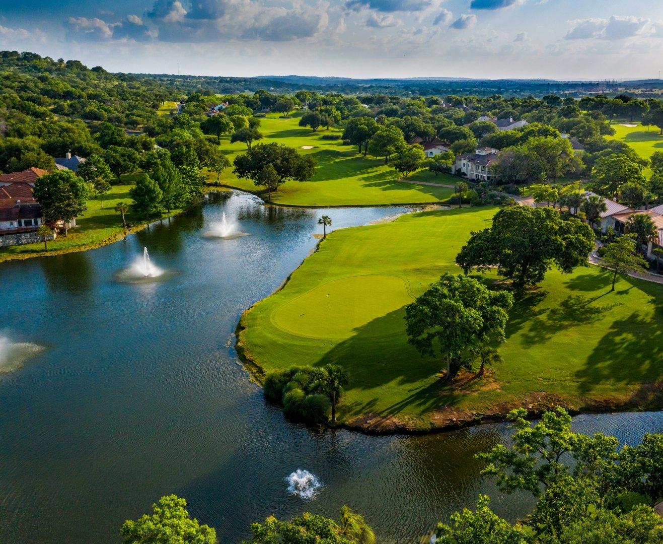 Lush fairways and sparkling fountains create a picturesque setting on the lakeside golf course.