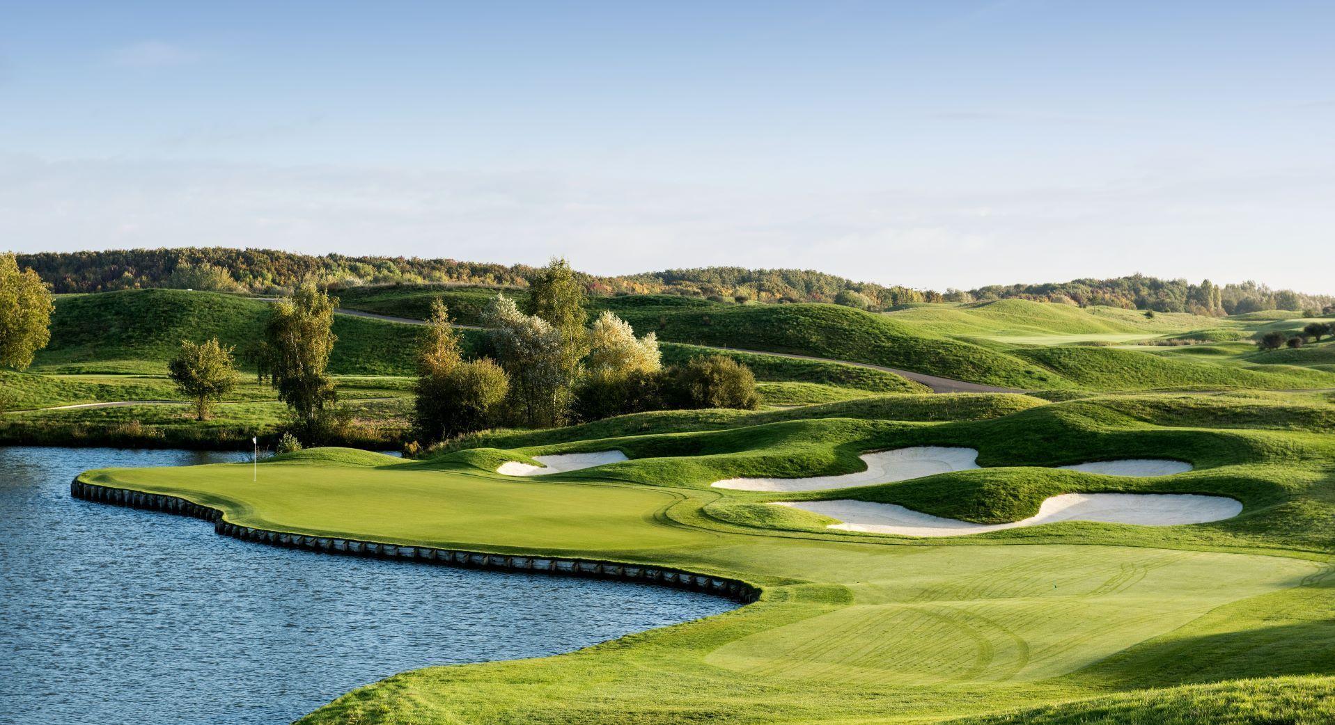 Undulating green with water in front