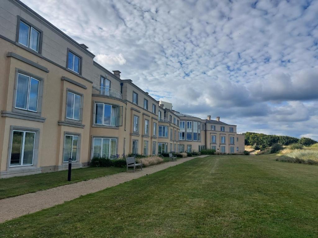 The exterior of a resort building surrounded by grass and pathways.