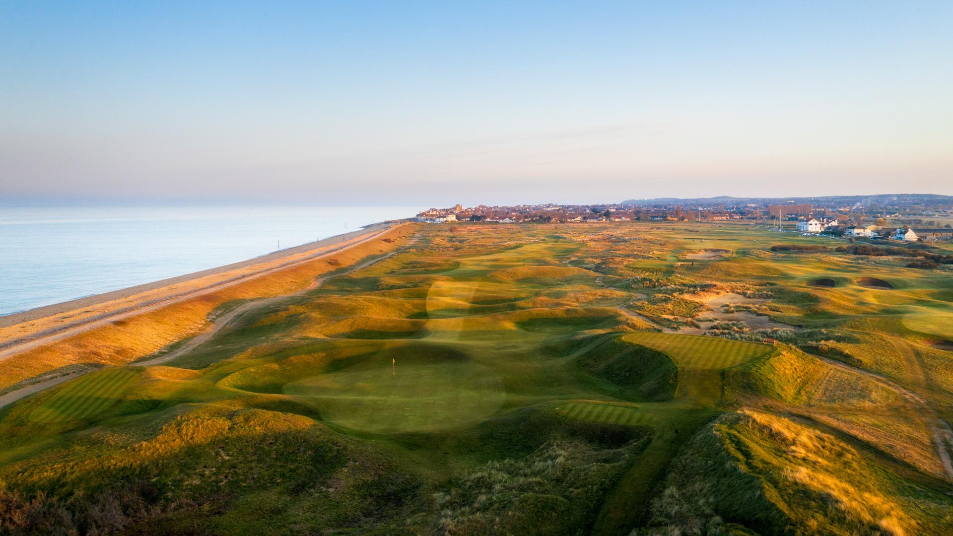 Scenic coastal course leading toward a seaside town.