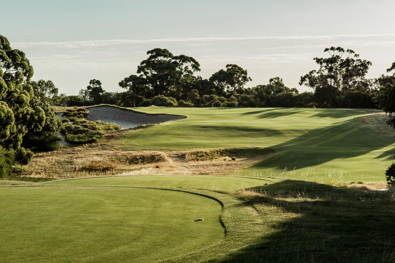 A winding fairway under the golden sun at the Royal Melbourne Golf Club