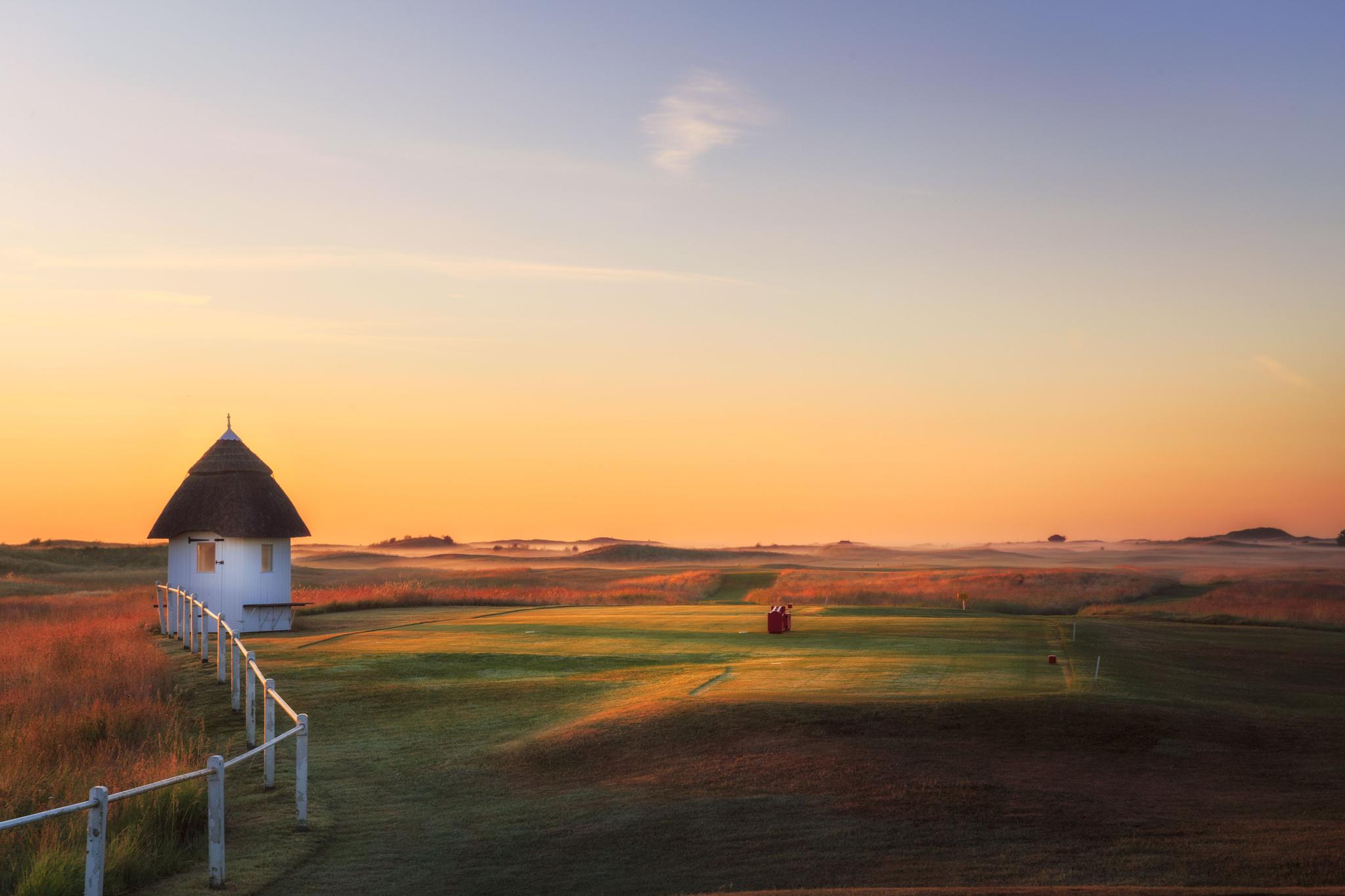 Sun setting over the course enhancing its yellow rough