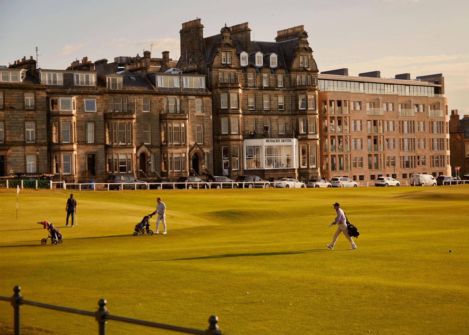 Historic Rusacks St Andrews hotel beside a scenic golf course.