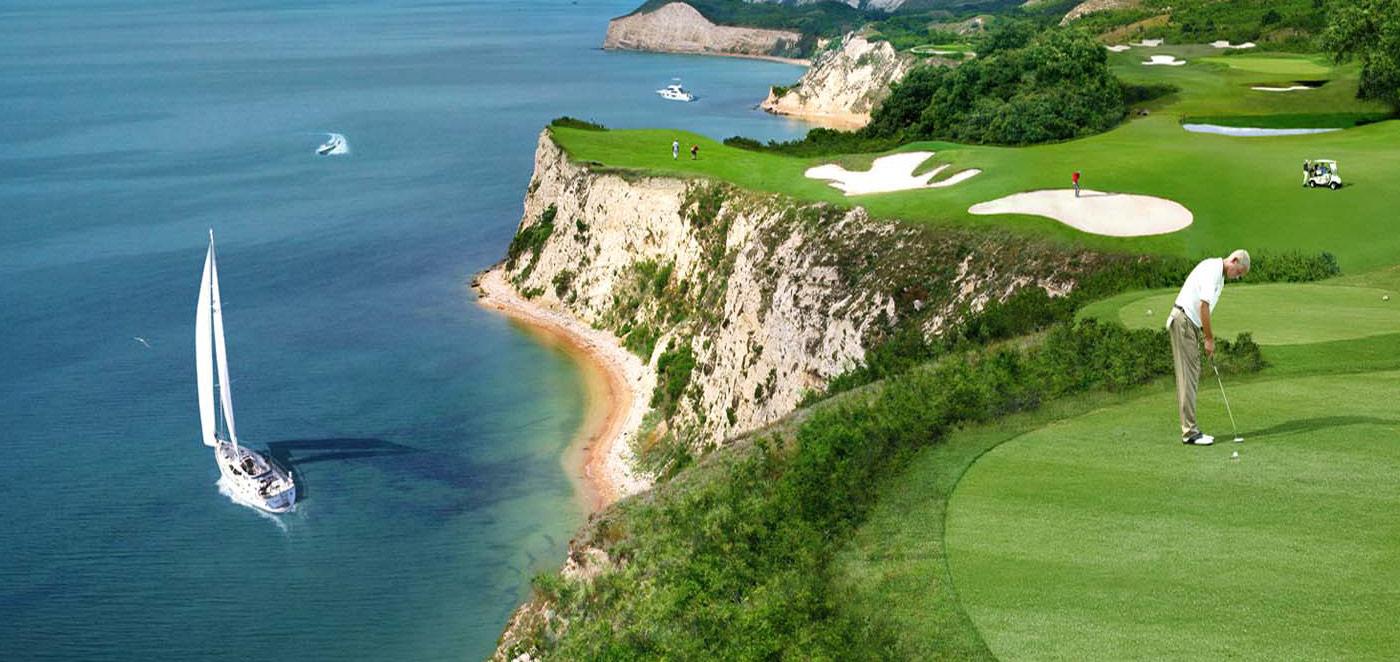Stunning cliffside hole with views of the ocean and sailboats.