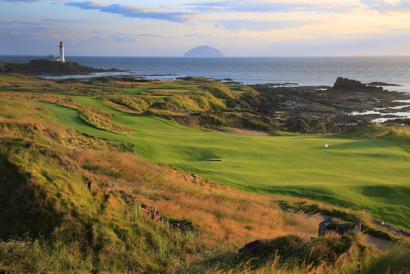 A sweeping golf course view with the lighthouse and distant island on the horizon.