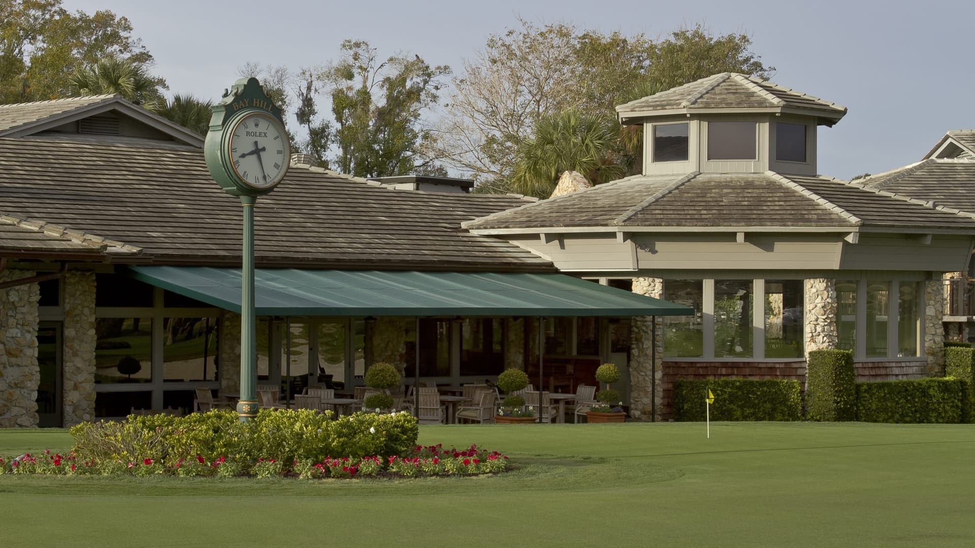 The clubhouse with a Rolex clock tower outside of the building