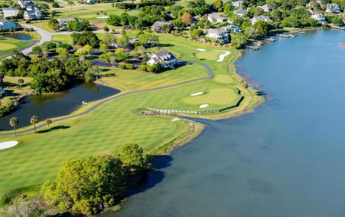 Aerial view of the Oak point course neighbouring a large pond and local houses