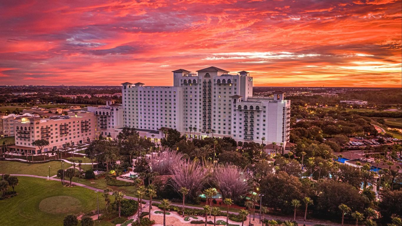 Exterior view of the Omni Orlando Resorts hotel building under golden skies
