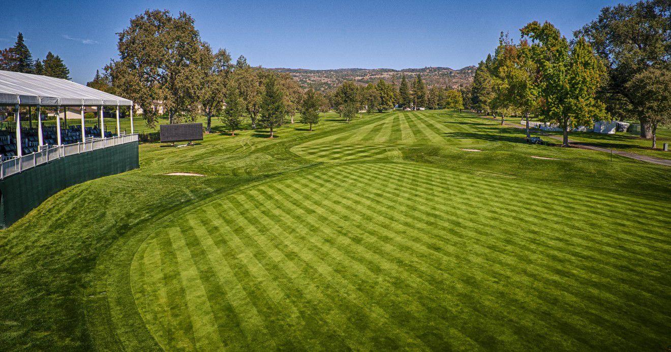 A well maintained fairway with mountain views in the distance