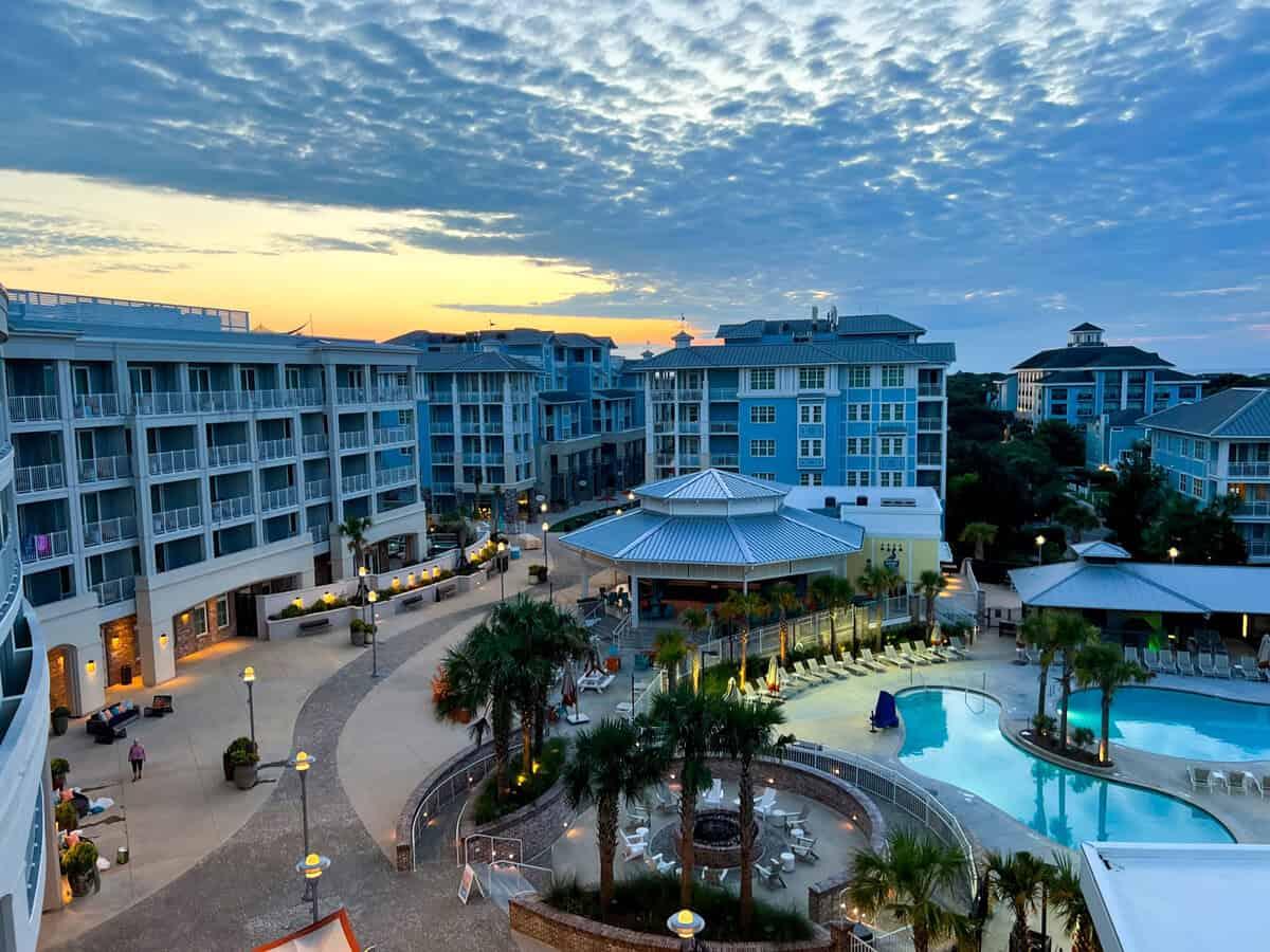 Sun setting over the resort building and swimming pool