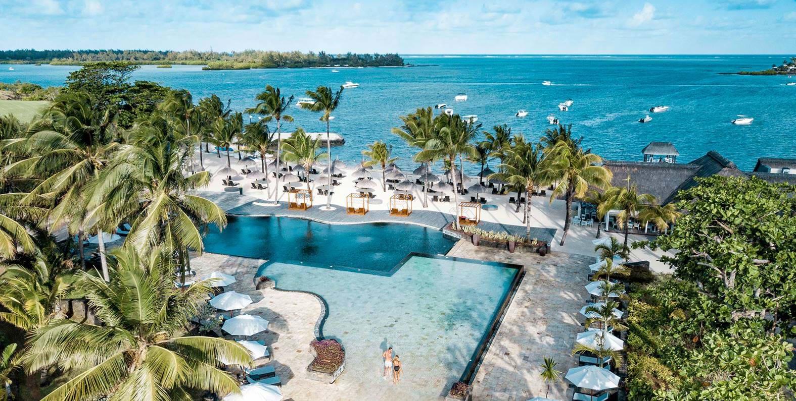 Overhead view of the outdoor swimming pool at the Anahita Golf & Spa Resort leading to the beach