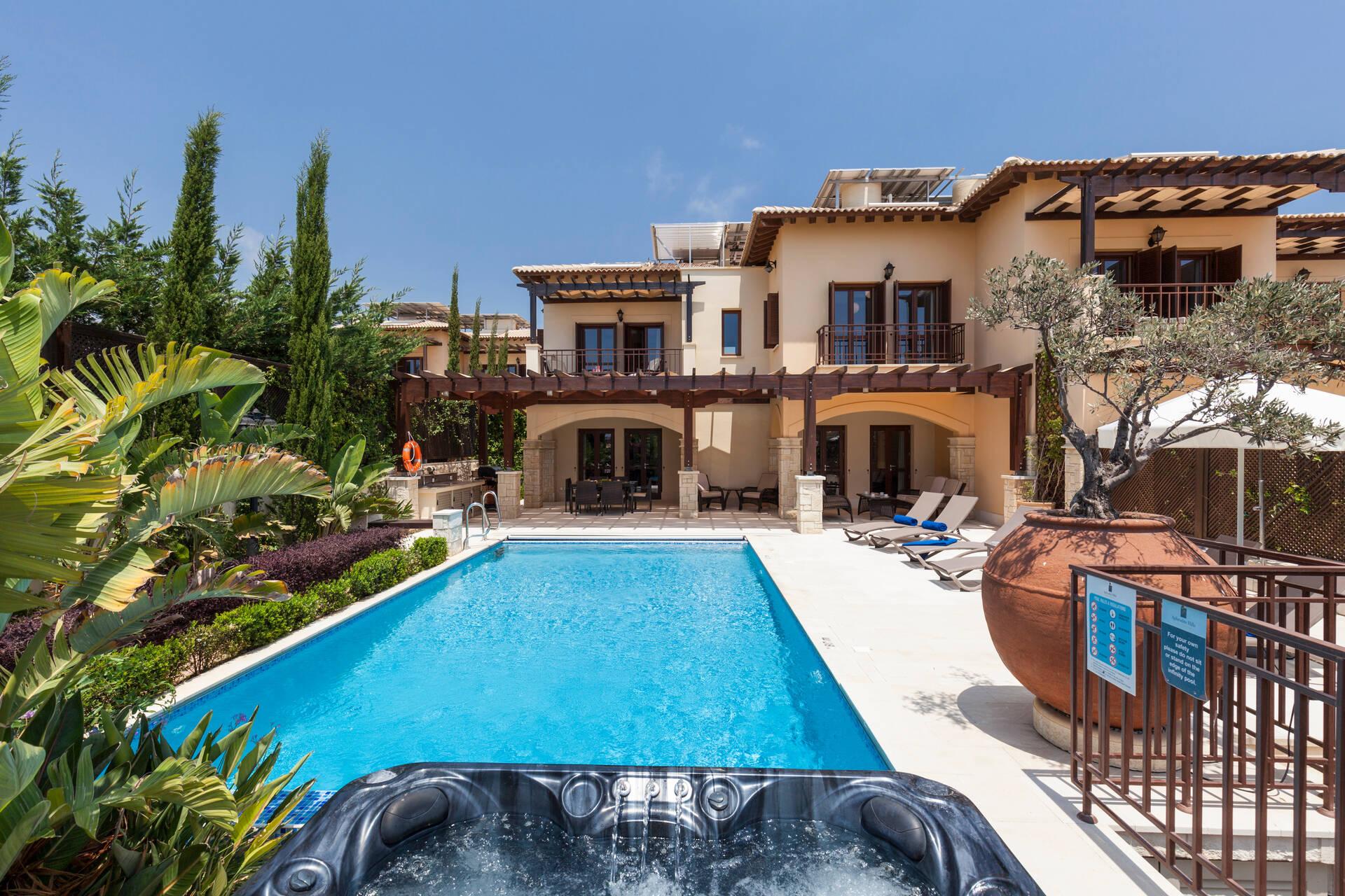 A personal outdoor swimming pool, jacuzzi and sunbeds as part of a villa
