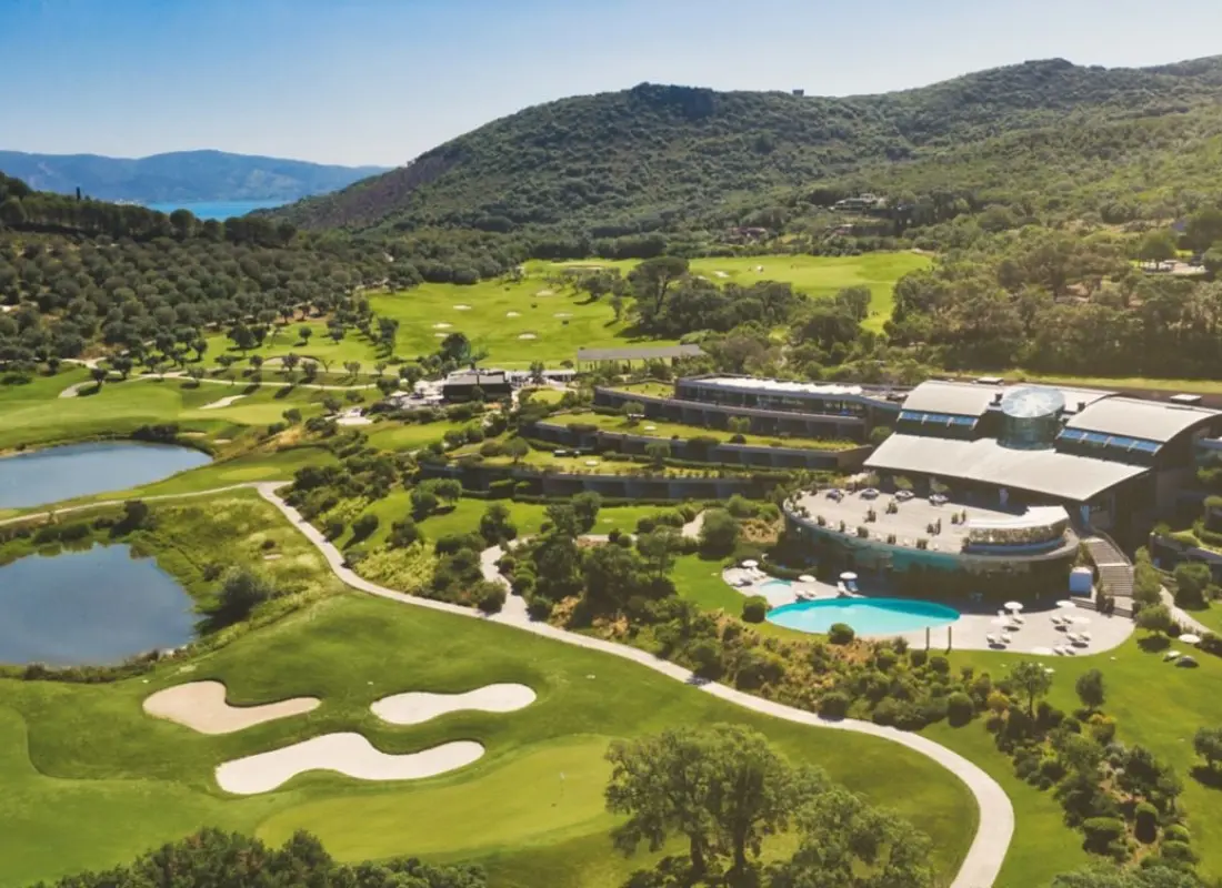 Overhead view of the Argentario Golf & Wellness Resort with an outdoor swimming pool looking out onto the course