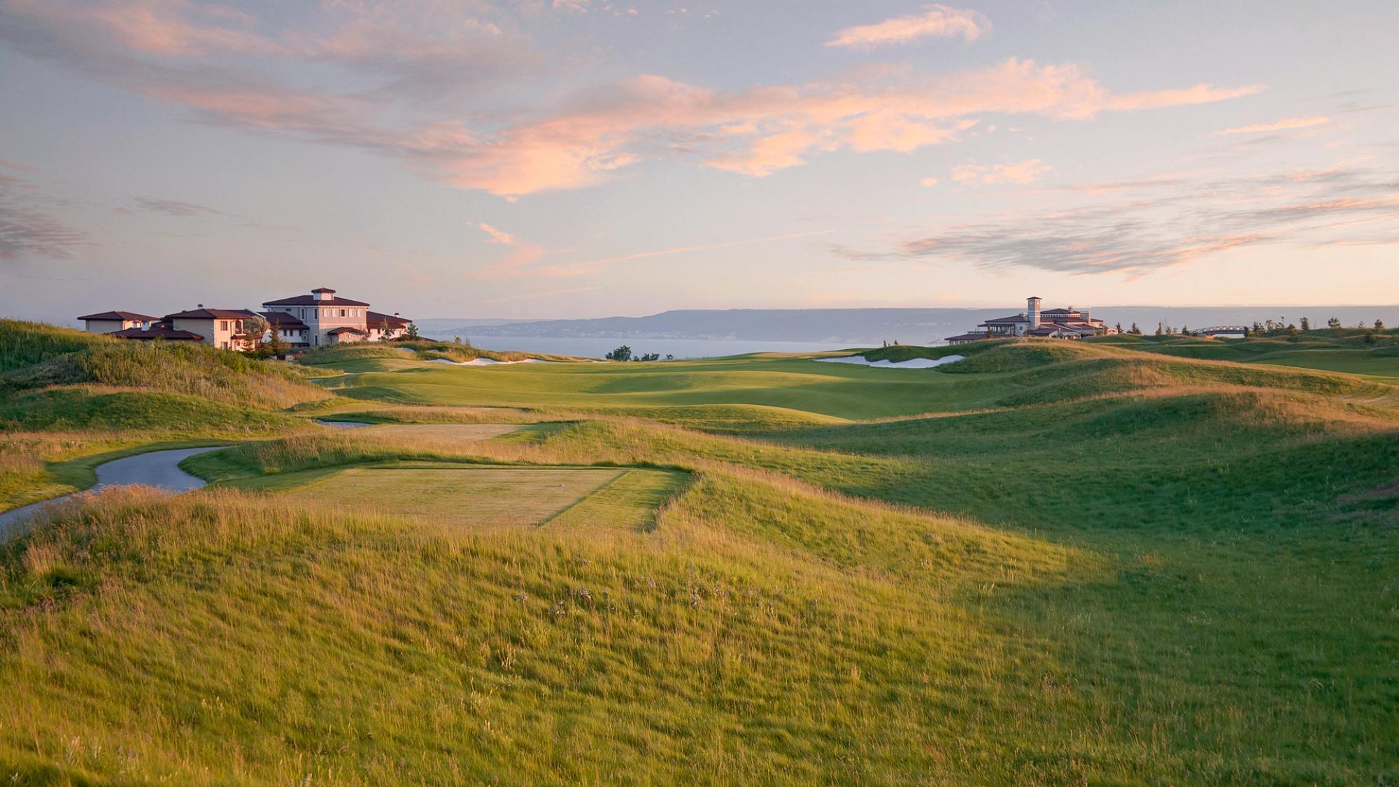 Tee off into rolling dunes on the fairway with coastal views in the distance