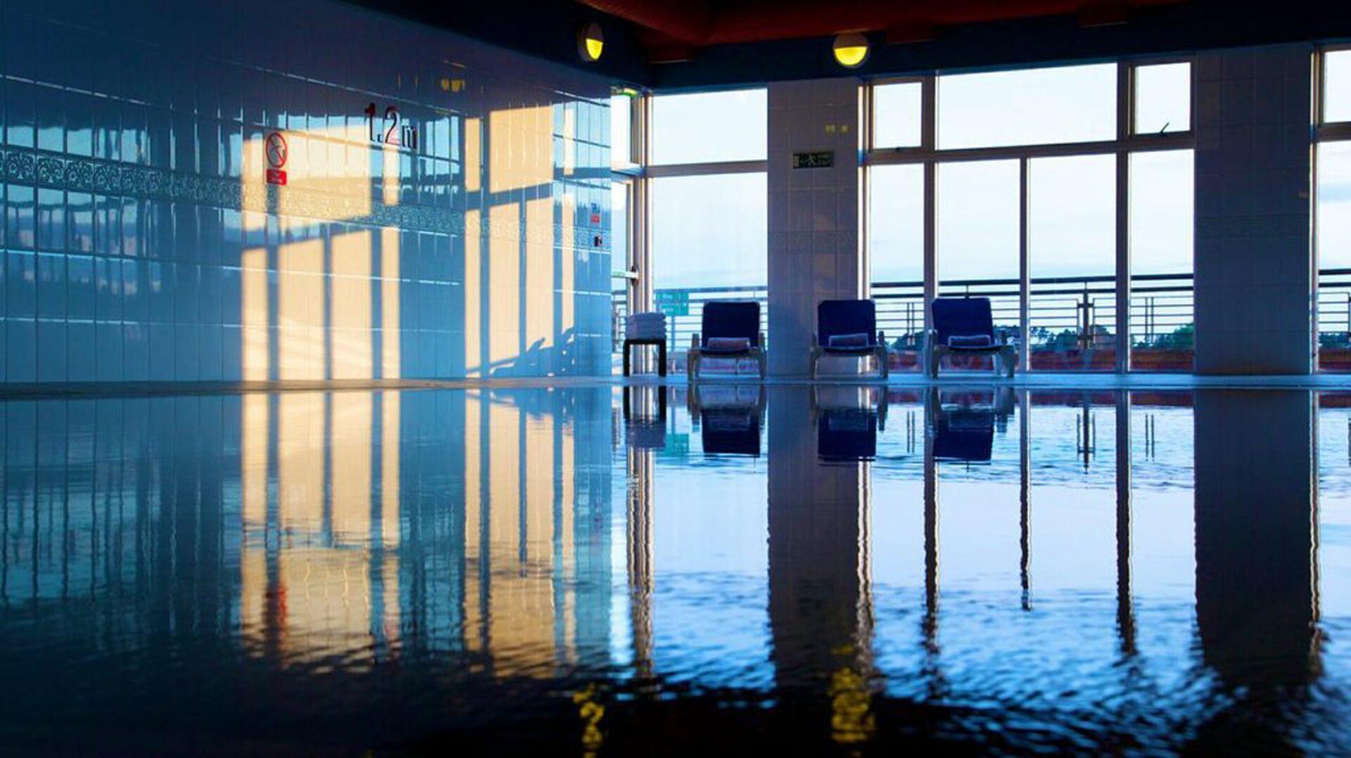 Indoor swimming pool at the Carnoustie resort with a panoramic window for views of the course