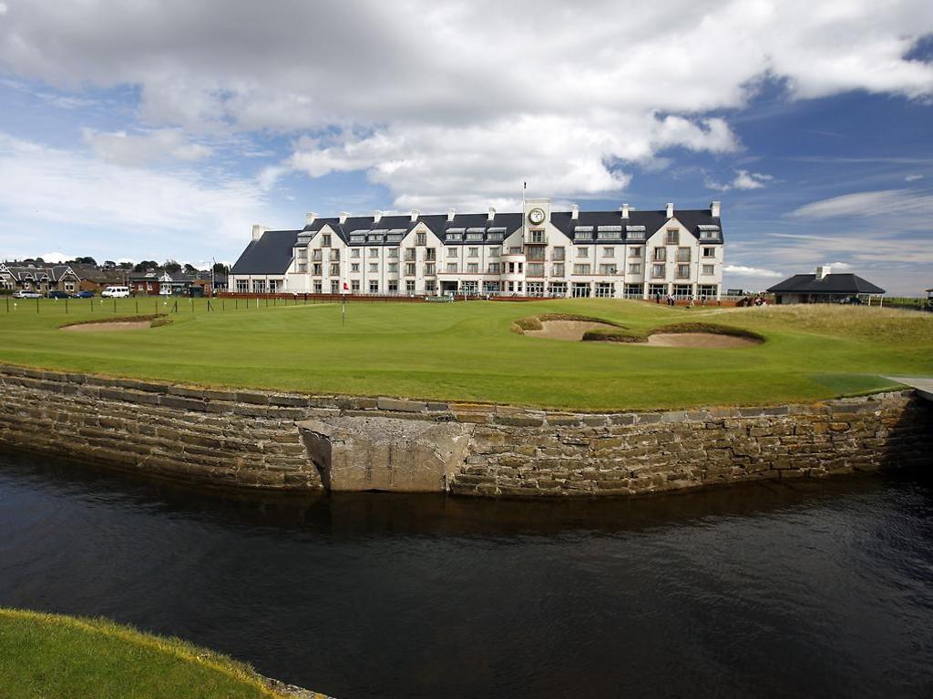 Exterior view of the Carnoustie Resort looking out onto the course featuring a lake with stone reinforcements