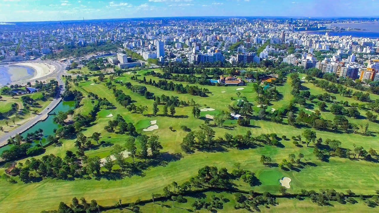 Aerial view of a large golf course next to a city