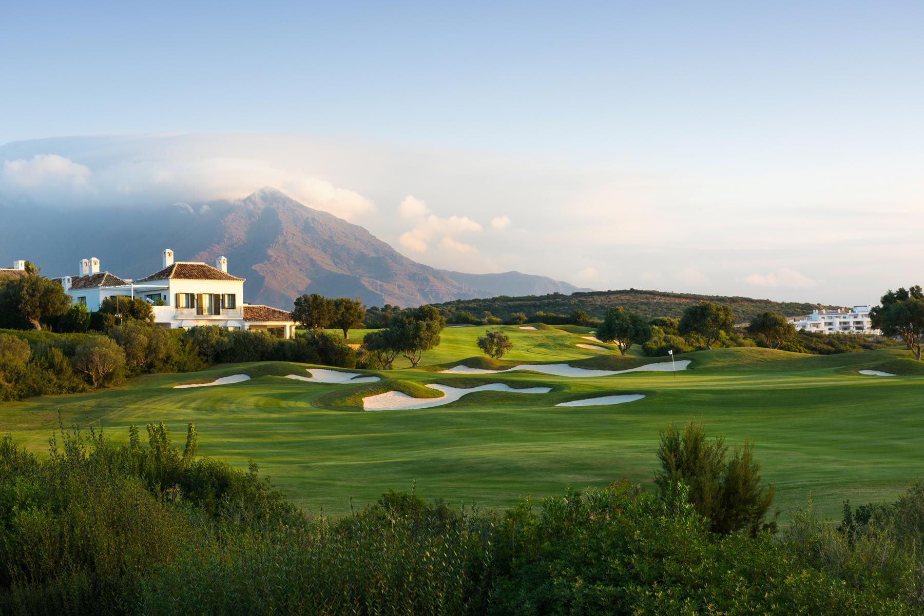 Winding fairway leading to a green surrounded by bunkers