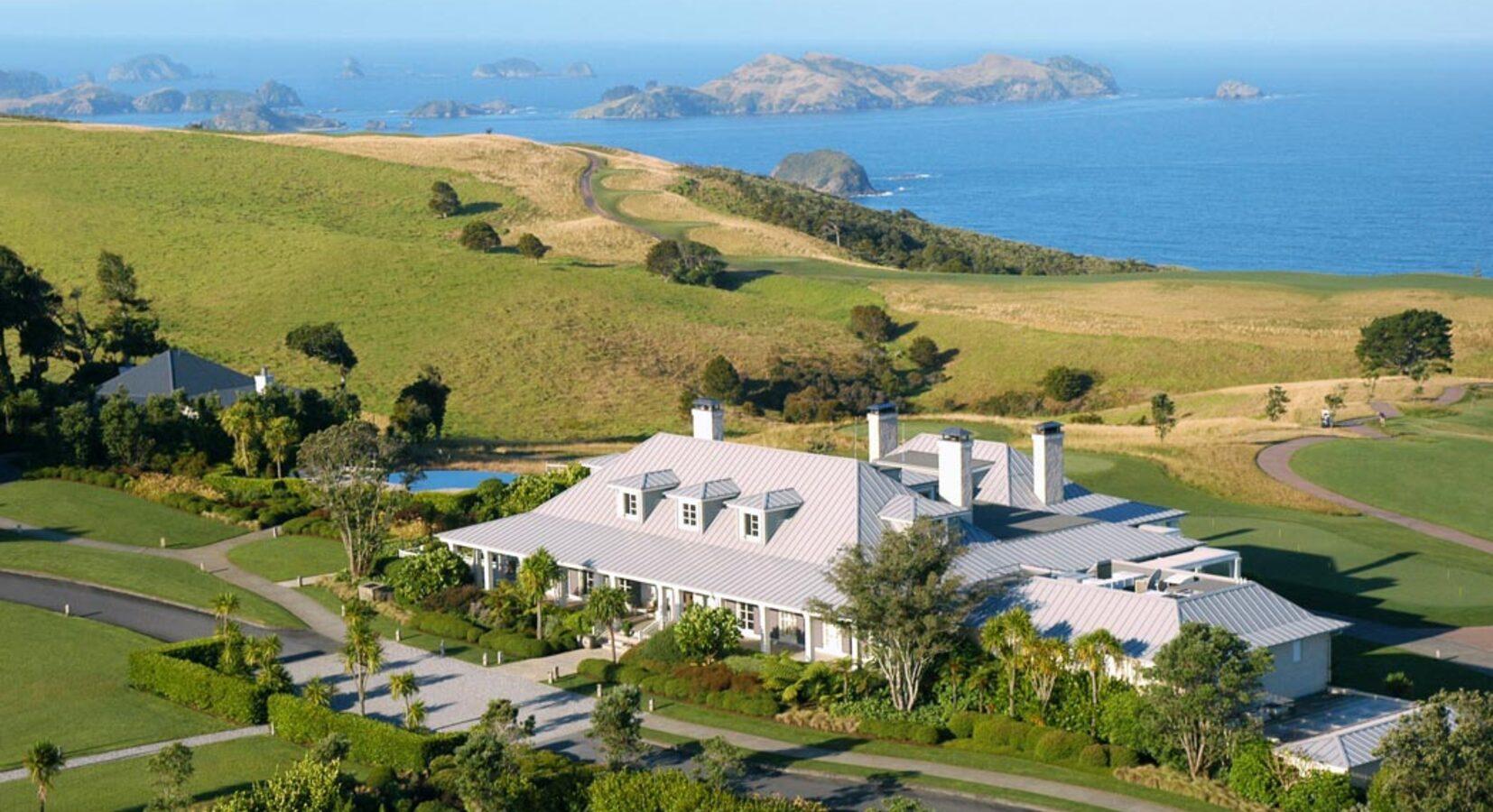 Birdseye view of the Kauri Cliffs Resort clubhouse with sea views in the background