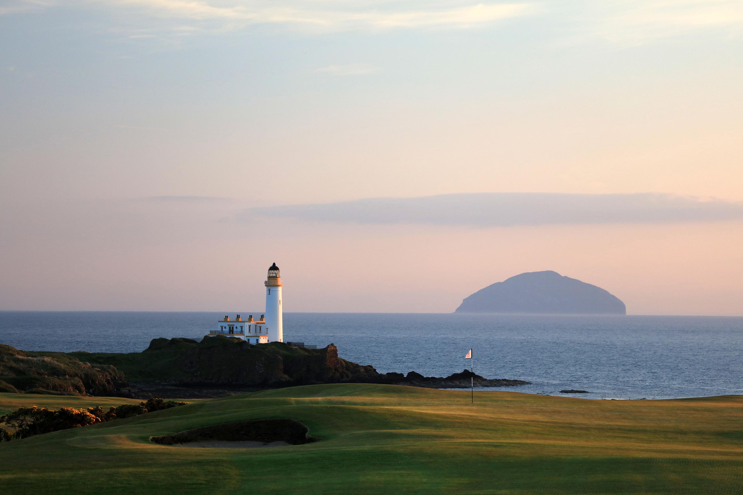 Smooth green with a strategically places sand bunker leading towards the coast