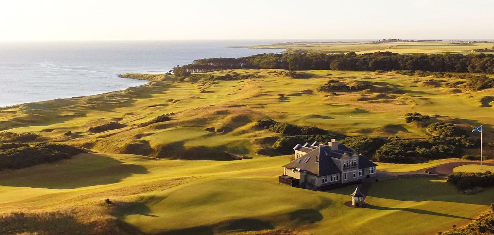 A sweeping links course with rolling dunes and a clubhouse overlooking the coastline.